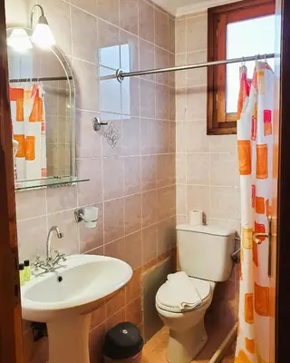 a bathroom with a toilet and a sink at Diporto in Chania Town