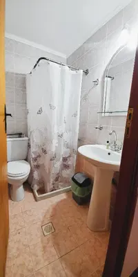 a bathroom with a shower and a sink and a toilet at Diporto in Chania Town