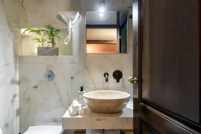 a bathroom with a large bowl sink on a counter at Porto Del Colombo Traditional Boutique Hotel in Chania Town
