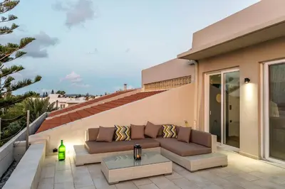 a patio with a couch and a table at Villa AERAS in Kato Daratso