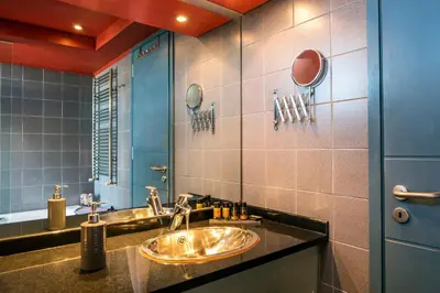 a bathroom with two sinks and a mirror at Villa AERAS in Kato Daratso