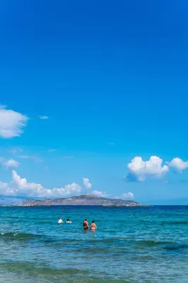 a group of people in the water at the beach at Villa AERAS in Kato Daratso