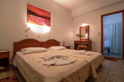 a bedroom with a bed with towels on it at Roula Apartments in Palaiochóra