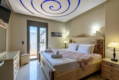 a bedroom with a large bed with a circular ceiling at Evgenias Luxury Apartment with Rooftop Pool in Chania Town