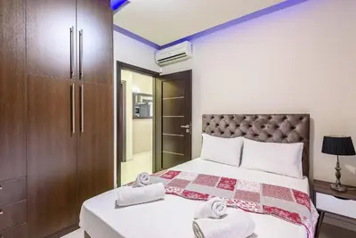 a bedroom with a bed and a closet at Evgenias Luxury Apartment with Rooftop Pool in Chania Town