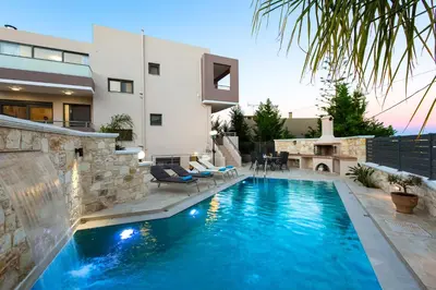 a swimming pool in the backyard of a house at Peris Villa in Kato Daratso