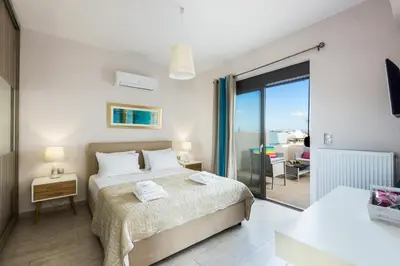 a bedroom with a bed and a view of the ocean at Peris Villa in Kato Daratso