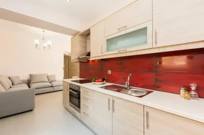 a kitchen with a sink and a living room at Peris Villa in Kato Daratso