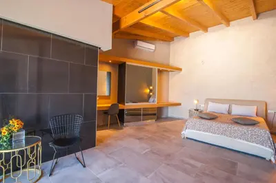 a bedroom with a bed and a desk at Minoos Hotel in Chania Town