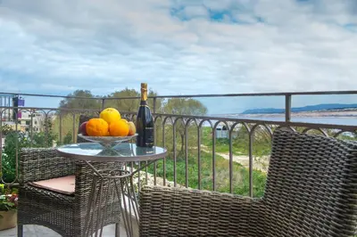 a bowl of fruit on a table on a balcony at Minoos Hotel in Chania Town