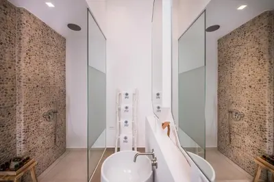 a bathroom with a toilet and a glass wall at Madonna del Mare in Chania Town