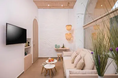 a living room with a couch and a tv at Madonna del Mare in Chania Town