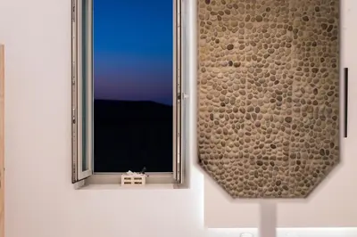 a window in a white wall with a view at Madonna del Mare in Chania Town