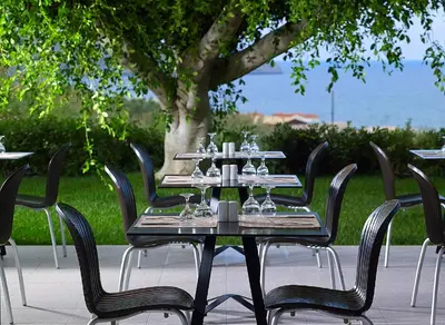 a table with wine glasses on top of it at Eleftheria Hotel in Agia Marina Nea Kydonias
