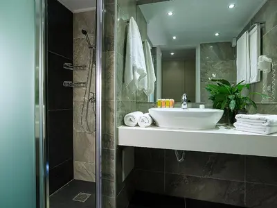 a bathroom with a sink and a shower at Eleftheria Hotel in Agia Marina Nea Kydonias