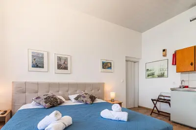 a bedroom with a blue bed with towels on it at Villa Venezia in Chania Town