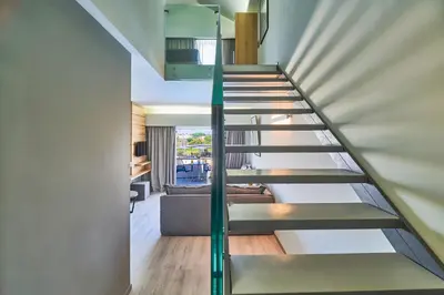 a spiral staircase in a house with a living room at Bella Pais in Maleme