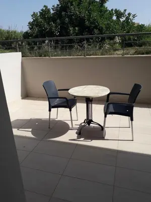 a table and two chairs and a table on a roof at Bella Pais in Maleme