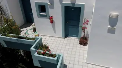 a house with two planters with plants in it at Hotel Kleopatra in Stalos