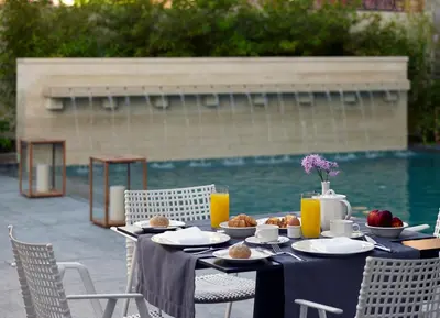 a table with food on it next to a pool at Samaria Hotel in Chania Town