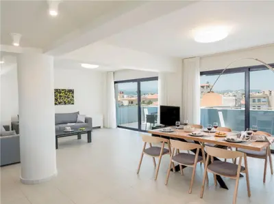 a dining room with a table and chairs and a couch at Spring Apartments in Chania Town