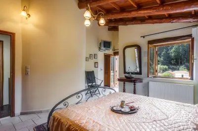 a bedroom with a bed with a table on it at Ifigenia Lux MAISONETTE in oldtown and Villas in theriso vilage 14 km outside of chania in Chania Town