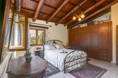 a bedroom with a bed and a table in it at Ifigenia Lux MAISONETTE in oldtown and Villas in theriso vilage 14 km outside of chania in Chania Town