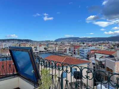 a view of a city from a balcony at Ifigenia Lux MAISONETTE in oldtown and Villas in theriso vilage 14 km outside of chania in Chania Town