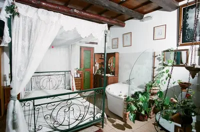 a bathroom with a tub and a bed and a bath tub at Ifigenia Lux MAISONETTE in oldtown and Villas in theriso vilage 14 km outside of chania in Chania Town