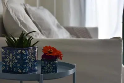 a table with two vases and a plant on it at GT Beach in Maleme