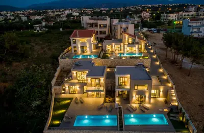 an aerial view of a mansion at night at Eland Dream Villas in Kalamaki Chanion