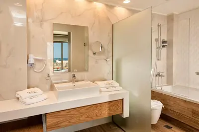 a white bathroom with a sink and a mirror at Eland Dream Villas in Kalamaki Chanion