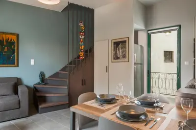 a kitchen and dining room with a table and chairs at Casa Giulietta Modern Luxury Maisonette in Chania Town