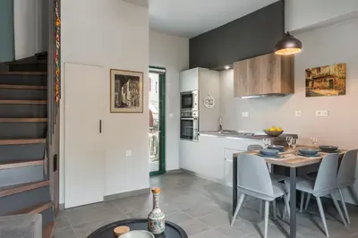a kitchen and dining room with a table and chairs at Casa Giulietta Modern Luxury Maisonette in Chania Town