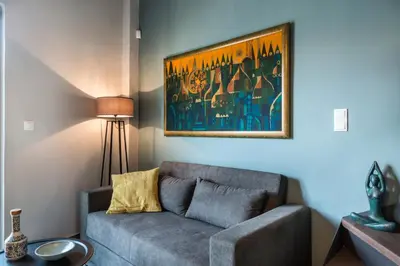 a living room with a couch and a painting on the wall at Casa Giulietta Modern Luxury Maisonette in Chania Town