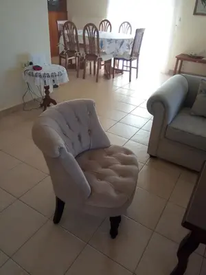 a living room with a chair and a couch at Beachway home in Kato Daratso