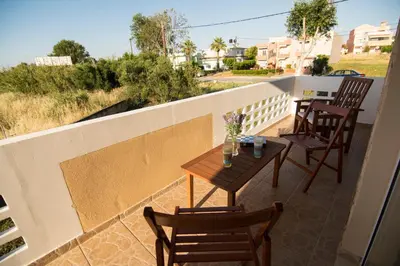 a table and chairs on a balcony with a view at Beachway home in Kato Daratso