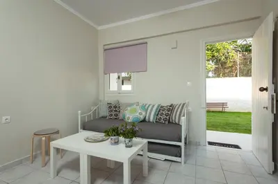 a living room with a couch and a table at Popy's Place in Kato Daratso