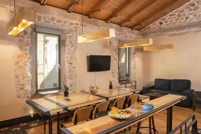 a dining room with a table and a couch at Evans House in Chania Town