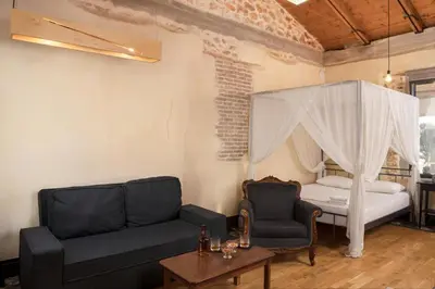 a living room with a couch and a bed at Evans House in Chania Town