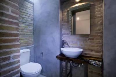 a bathroom with a sink and a toilet and a mirror at Evans House in Chania Town