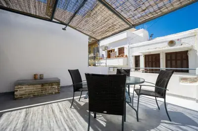 a kitchen and dining room with a table and chairs at Evans House in Chania Town