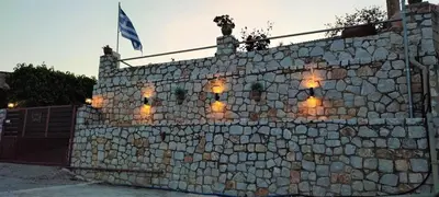 a stone wall with lights on top of it at Aoria Traditional House with Stuning Mountain View in Loúlos