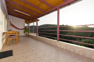 a balcony with a table and a view of the mountains at Aoria Traditional House with Stuning Mountain View in Loúlos