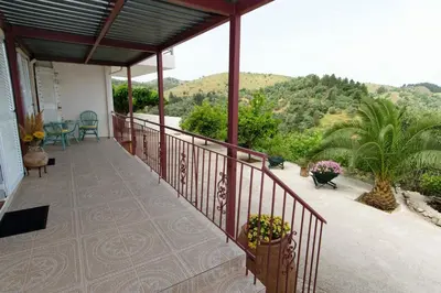 a balcony of a house with a view of the mountains at Aoria Traditional House with Stuning Mountain View in Loúlos