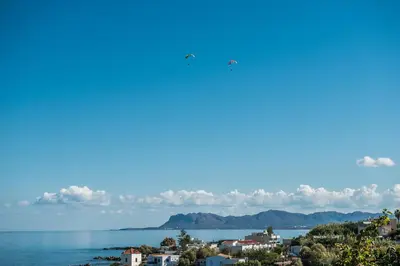 two planes flying over a city and the ocean at Thea Thalassa in Kalamaki Chanion