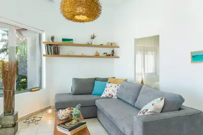 a living room with a couch and a table at Thea Thalassa in Kalamaki Chanion