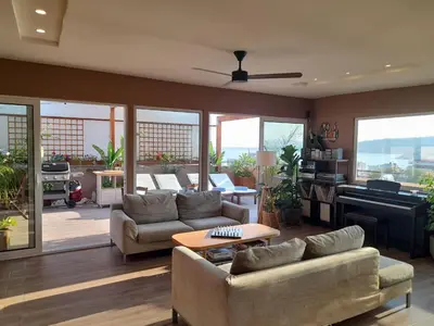 a living room with two couches and a piano at ChaniaStay Central Apartments in Chania Town
