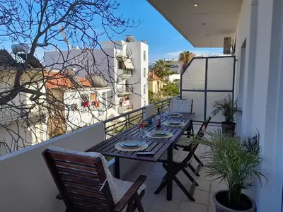 a table and chairs on a balcony with a view at ChaniaStay Central Apartments in Chania Town