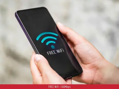 a person holding a cell phone with a free wifi symbol on it at ChaniaStay Central Apartments in Chania Town